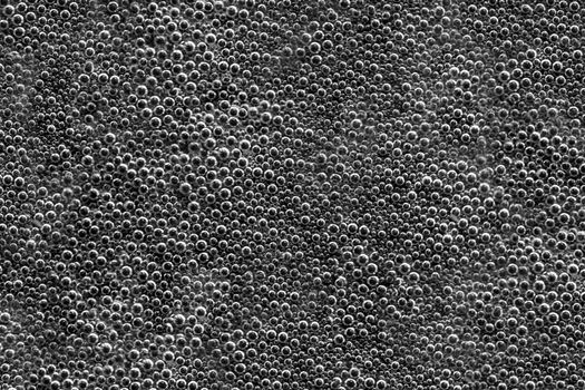 Texture of water bubbles on a black background. Soft focus