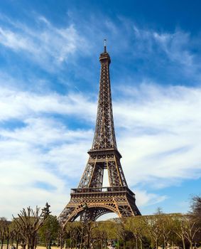 Eiffel Tower in Paris France against blue sky with clouds. April 2019