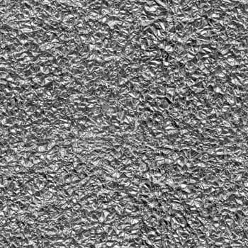 Seamless texture of crumpled aluminum leaf foil, close-up.