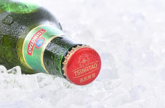 IRVINE, CA - AUGUST 26, 2016: A bottle of Tsingtao Beer. Tsingtao is China's second largest brewery, it was founded in 1903 by German settlers.