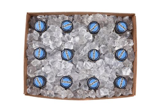 IRVINE, CALIFORNIA - 10 MAR 2020: High angle view of a 12 pack of Blue Moon Belgian White Ale with ice cubes in the box.