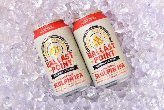 IRVINE, CALFORNIA - FEBRUARY 17, 2019: Two cnas of Ballast Point Grapefruit Sculpin IPA, on a bed of ice. 