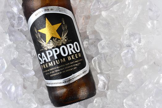 IRVINE, CA - JANUARY 12, 2015: A bottle of Sapporo Beer closeup on a bed of ice. The Japanese brewery was founded in 1876 by German trained brewer Seibei Nakagawa. It is the oldest beer brand in Japan.