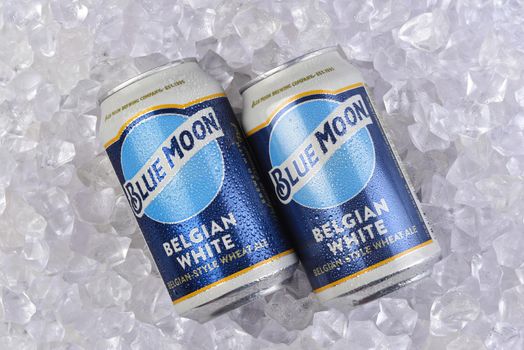 IRIVNE, CALIFORNIA - 17 JUL 2021: Two cans of Blue Moon Belgian White Ale in a bed of Ice.