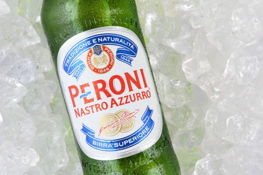 IRVINE, CA - JANUARY 11, 2015: A single bottle of Peroni Beer on a bed of ice. Founded n the town of Vigevano, Italy in 1846. The company was moved to Rome by Giovanni Peroni in 1864.