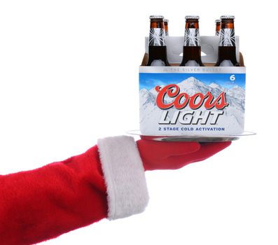 IRVINE, CALIFORNIA - 4 SEPT 2020: Santa Claus holding a serving tray with a 6 pack of Coors Light Beer over a white background.