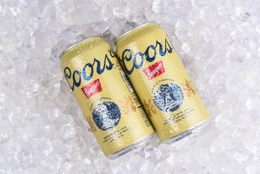 IRVINE, CALIFORNIA - AUGUST 19, 2019: 2 cans of Coors Banquet Beer on ice. Brewed solely in Golden, Colorado with Rocky Mountain water and Moravian barley.