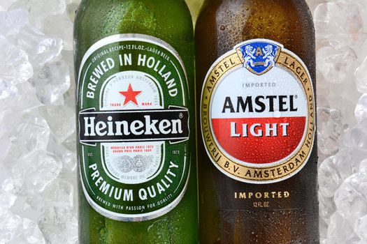 IRVINE, CA - JANUARY 12, 2015: A bottle of Amstel Light and Heineken Beer. Since 1975, most Heineken beer has been brewed at the  brewery in Zoeterwoude, Netherlands.