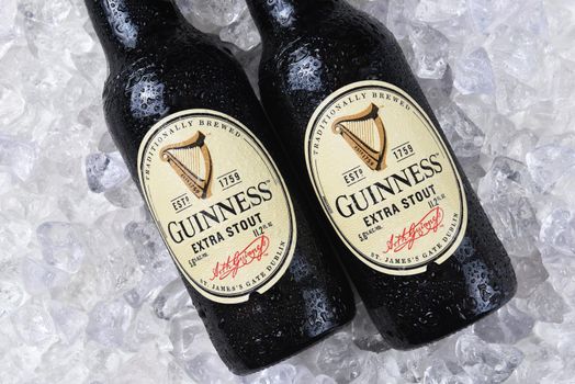 IRVINE, CA - December 15, 2017: Two bottles of Guinness Extra Stout on a bed of ice. The Irish beer is one of the worlds most successful beer brands with annual sales over 850 million liters.