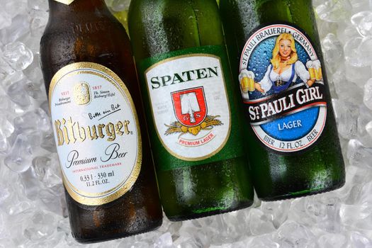 IRVINE, CA - JANUARY 11, 2015: Three bottles of German beerson a bed of ice. St. Pauli Girl, Spaten and Bitburger are three popular German beers imported into the United States.