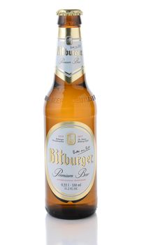 IRVINE, CA - JANUARY 11, 2015: A bottle of Bitburger Beer isolated on white. Bitburger is a German family business with around  that in 2012 produced around 750 million litres of beer.