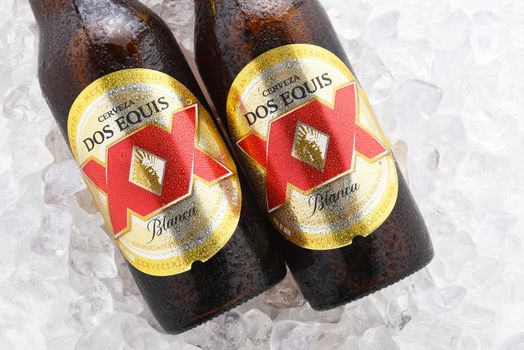 IRVINE, CA - JUNE 14, 2017: Dos Equis Blanca on ice. Two bottles of the wheat beer from Cuauhtemoc-Moctezuma Brewery in Monterrey, Mexico a subsidiary of Heineken International.