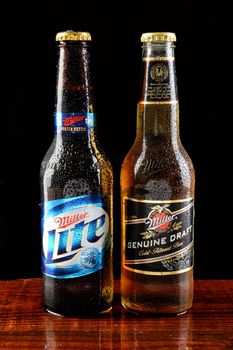 IRVINE, CALIFORNIA - 18 JUNE 2015: A bottle of Miller Lite and Miller Genuine Draft beer on a wet bar countertop. 