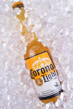 IRVINE, CALIFORNIA - MARCH 29, 2018: Closeup of a bottle of Corona Light beer bottle in ice. Corona is the most polular import in the USA.