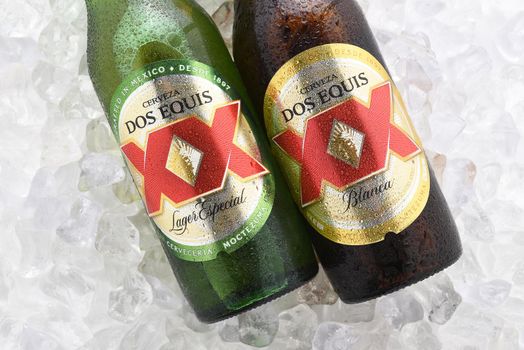 IRVINE, CA - JUNE 14, 2017: Dos Equis Blanca and Especial on ice. Two bottles the beer from Cuauhtemoc-Moctezuma Brewery in Monterrey, Mexico a subsidiary of Heineken International.