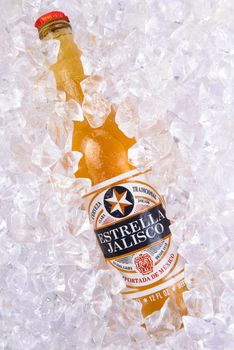IRVINE, CALIFORNIA - MARCH 29, 2018: Closeup of a bottle of Estrella Jalisco beer in ice.  Estrella Jalisco is a American Lager style beer brewed by Grupo Modelo.
