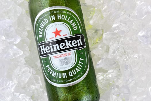 IRVINE, CA - JANUARY 12, 2015: A bottle Heineken Beer closeup on ice. Since 1975, most Heineken beer has been brewed at the  brewery in Zoeterwoude, Netherlands.