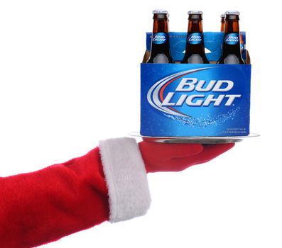 IRVINE, CALIFORNIA - 3 SEPT 2020: Santa Claus holding a serving tray with a 6 pack of Bud Light Beer over a white background.