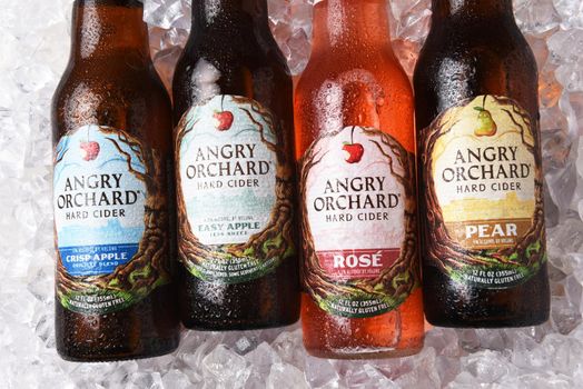 IRVINE, CALIFORNIA - OCTOBER 19, 2018: Four bottles of Angry Orchard Hard Cider on a bed of ice. Apple, Pear and Rose varieties are shown. 
