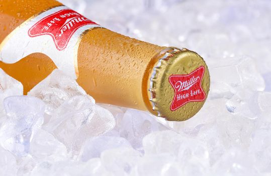 IRVINE, CA - APRIL 10, 2017: Miller High Life bottle on ice. High Life, a pilsner style beer, is Millers oldest brand entering the market in 1903