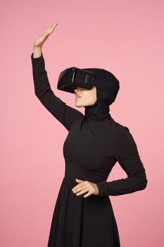 woman in black hijab glasses virtual reality technology movie watching. High quality photo