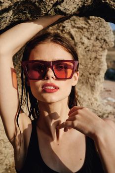 pretty woman in black swimsuit sunglasses posing sun. High quality photo