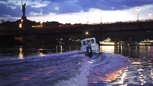 Boat with the motor floats with the lights turned on. Night Dnipro. High quality. 27 of July 2020. Kyiv, Ukraine. High quality 4k footage