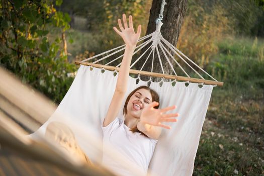 woman relaxing in nature in a hammock garden fresh air. High quality photo