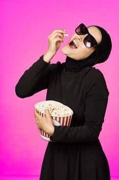 Muslim woman entertainment cinema popcorn fashion model ethnicity. High quality photo