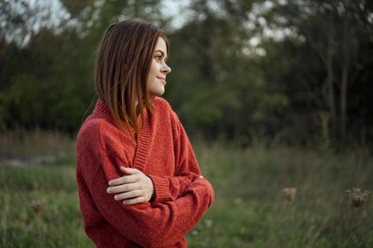 pretty woman in red sweater outdoors walk leisure. High quality photo