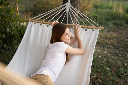 woman relaxing in nature in a hammock garden fresh air. High quality photo