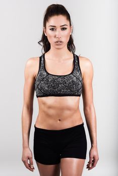 Young sport sexy fitness woman body posing on white background.