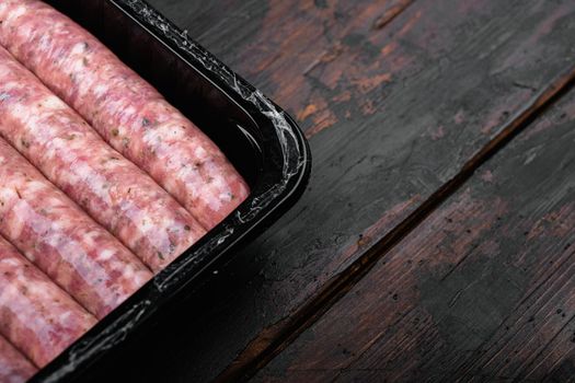 Fresh Polish Sausages pack set, on old dark wooden table background, with copy space for text