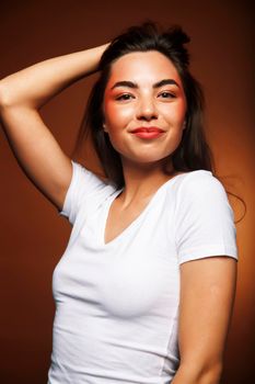 pretty girl happy posing: brunette on brown background, lifestyle people concept close up