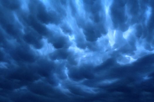 Dark blue rain clouds sky texture background.