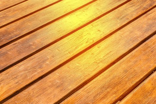 Diagonal wood surface texture with sunlight brown planks table background.