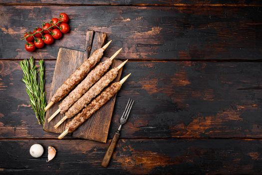 Tikka, shish and kofta kebabs set, on old dark wooden table background, top view flat lay, with copy space for text