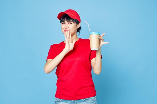 woman in red uniform cup of coffee blue background fun. High quality photo