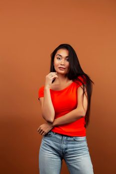 young pretty asian woman cheerful smiling posing on warm brown background, lifestyle people concept closeup