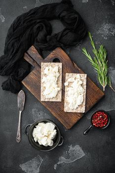 Crispbread sandwich set, on black dark stone table background, top view flat lay