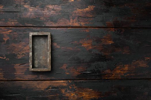 Empty dark wooden box set with copy space for text or food, top view flat lay, on old dark wooden table background