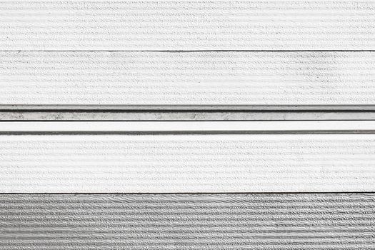 An element or part of the light white wooden facade of the house texture, a sample of the exterior of the building background, close-up.