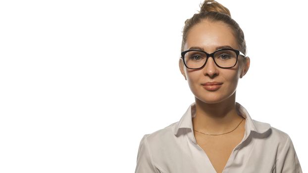 Beautiful nurse in eye glasses looking at the camera wearing white medical uniform isolated on white background.