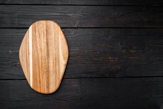 Pine wooden cutting board set, on black wooden table background, top view flat lay , with copy space for text or your product