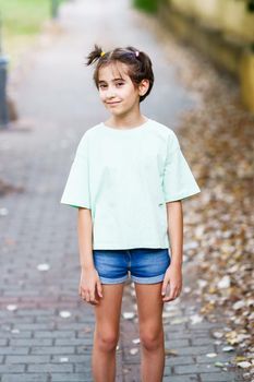 Adorable Nine-year-old girl standing in a city park