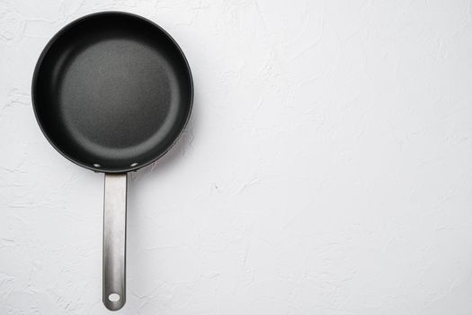 Empty skillet, frying pan set with copy space for text or food with copy space for text or food, top view flat lay, on white stone table background