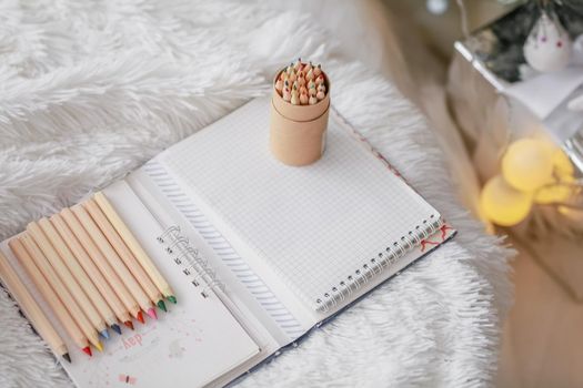 Christmas decorations boxes wrapped in wood colored paper and pencils made of wood.