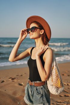woman walking on the beach landscape sun fun lifestyle. High quality photo