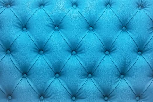 Blue natural leather sofa upholstery texture background.