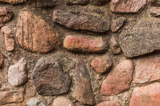 Large stones background or old cobblestones texture in concrete surface, close-up.